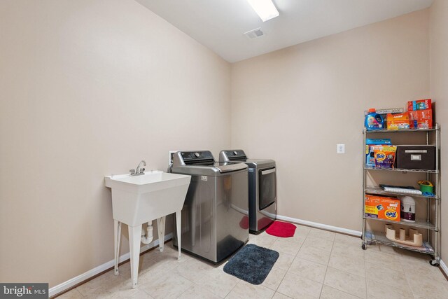 21550 Wild Timber Ct, Broadlands, VA 20148 - laundry area featuring washer and dryer, baseboards, and light tile patterned floors