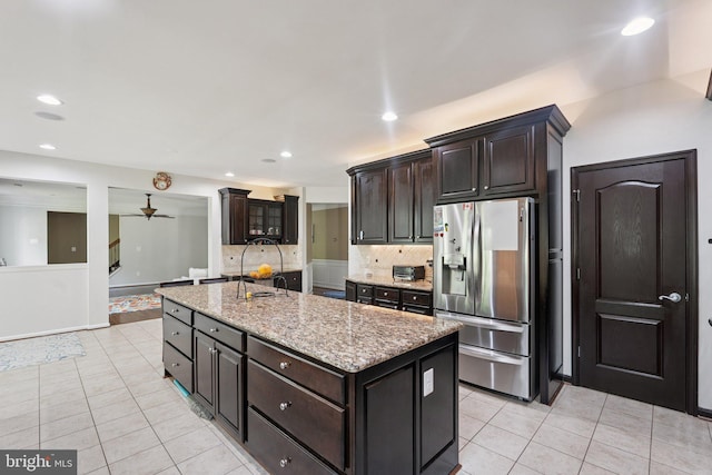 21550 Wild Timber Ct, Broadlands, VA 20148 - kitchen with stainless steel fridge, light tile patterned flooring, backsplash, recessed lighting, and light stone counters