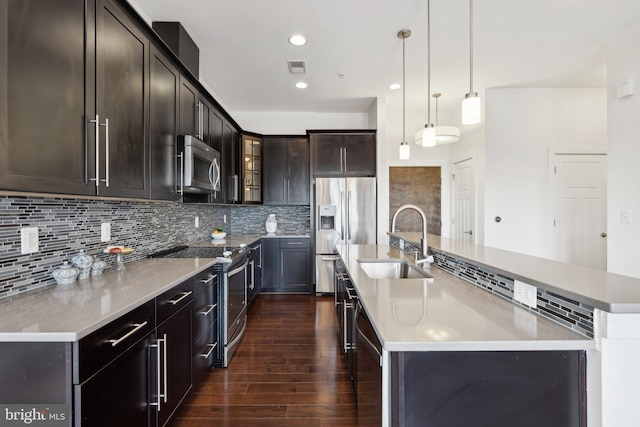 1107 S Walter Reed Dr S Unit 502, Arlington, VA 22204 - kitchen with stainless steel appliances, a sink, dark wood-type flooring, a spacious island, and decorative backsplash