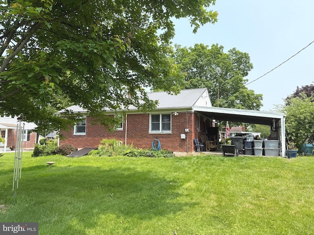 32 Meadow Ln, Gettysburg, PA 17325 - rear view of property featuring brick siding, a lawn, a carport, and a metal roof