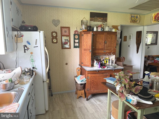 32 Meadow Ln, Gettysburg, PA 17325 - kitchen featuring wallpapered walls, brown cabinets, and freestanding refrigerator