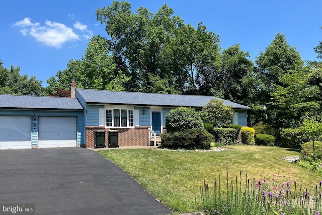2545 Pioneer Rd, Hatboro, PA 19040 - view of front facade featuring brick siding, an attached garage, a front lawn, and driveway