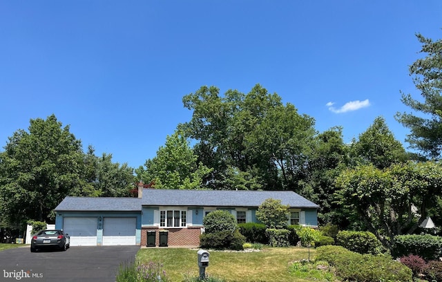 2545 Pioneer Rd, Hatboro, PA 19040 - single story home featuring an attached garage, a front lawn, asphalt driveway, a chimney, and brick siding