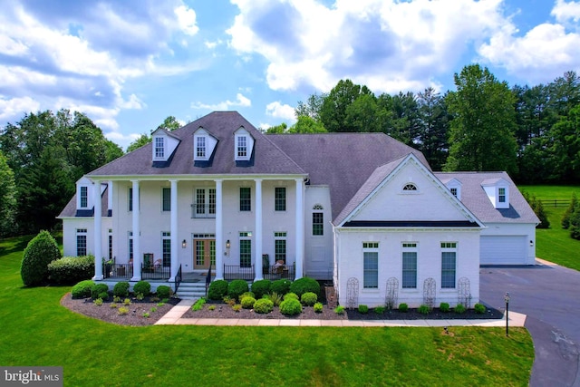 2506 Coulter Ln, Oakton, VA 22124 - greek revival house with a porch, a garage, a front lawn, and driveway