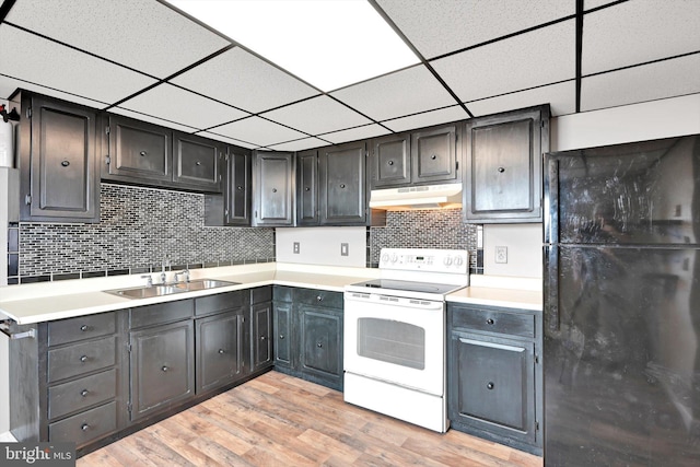 149 N Railroad Ave, Frackville, PA 17931 - kitchen featuring freestanding refrigerator, white range with electric stovetop, a sink, under cabinet range hood, and tasteful backsplash