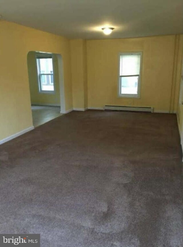 11 W Washington St, Paulsboro, NJ 08066 - carpeted spare room featuring baseboard heating, baseboards, and arched walkways