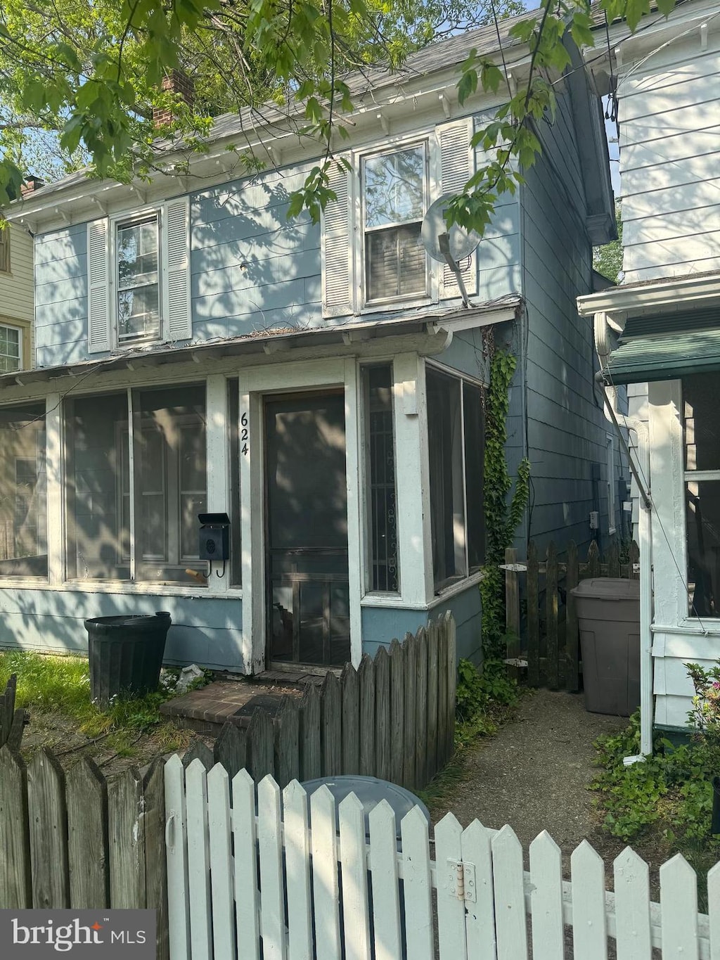 624 High St, Chestertown, MD 21620 - view of side of home featuring a sunroom and a fenced front yard