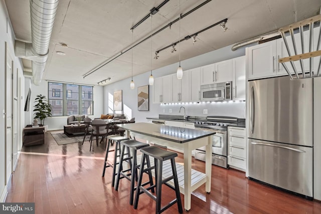2125 14th St NW Unit 618, Washington, DC 20009 - kitchen with appliances with stainless steel finishes, a sink, white cabinetry, and dark wood-style flooring