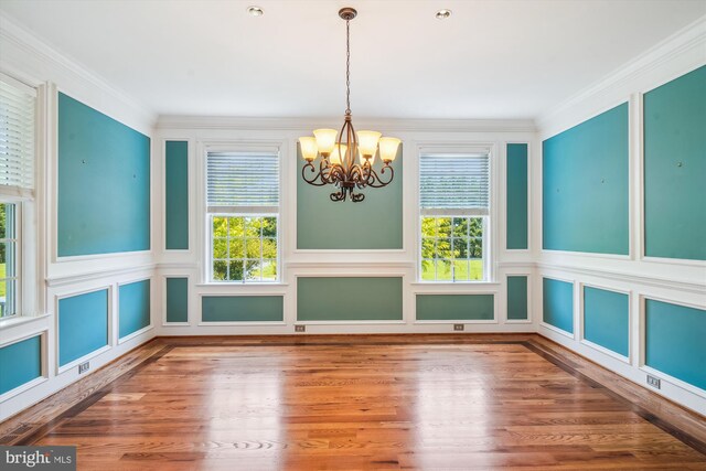 2375 Ballenger Creek Pike, Adamstown, MD 21710 - unfurnished dining area with a chandelier, wood finished floors, a decorative wall, and crown molding