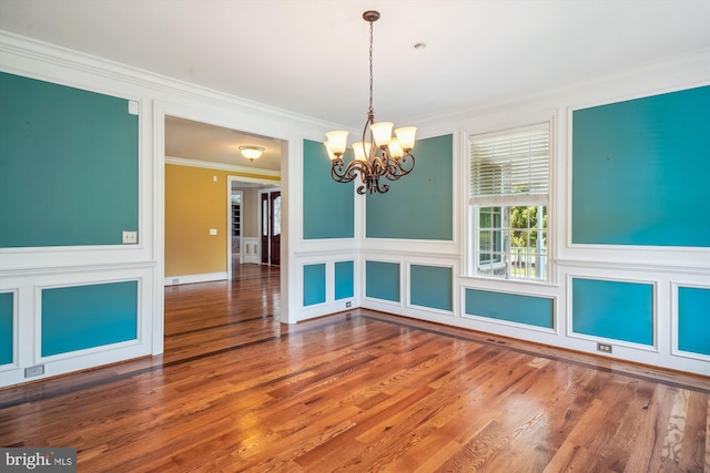 2375 Ballenger Creek Pike, Adamstown, MD 21710 - unfurnished dining area featuring a chandelier, crown molding, a decorative wall, wood finished floors, and wainscoting