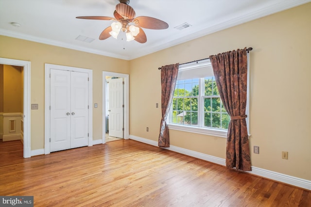 2375 Ballenger Creek Pike, Adamstown, MD 21710 - unfurnished bedroom with light wood finished floors, crown molding, baseboards, a closet, and ceiling fan