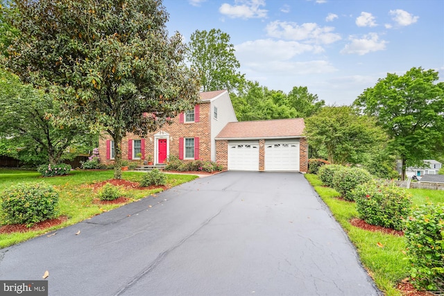14616 Orangewood St, Silver Spring, MD 20905 - colonial house with an attached garage, brick siding, and driveway