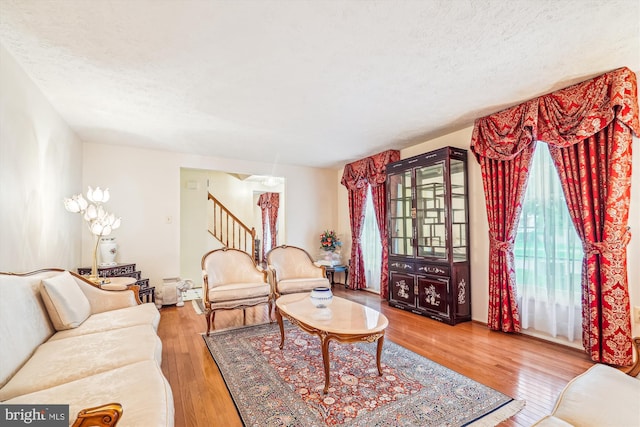 14616 Orangewood St, Silver Spring, MD 20905 - living room with stairs, wood finished floors, and a textured ceiling