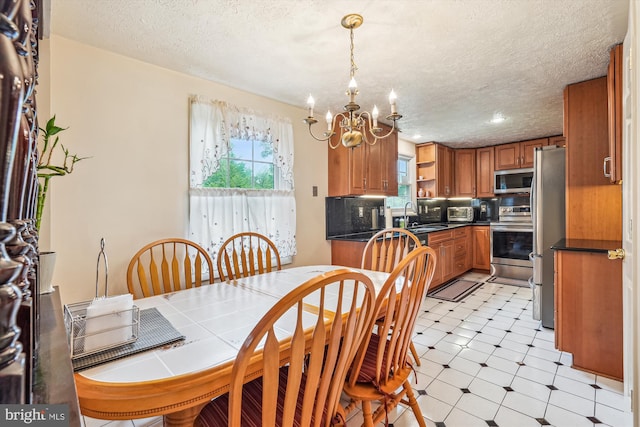 14616 Orangewood St, Silver Spring, MD 20905 - dining area featuring a chandelier, a textured ceiling, and light flooring