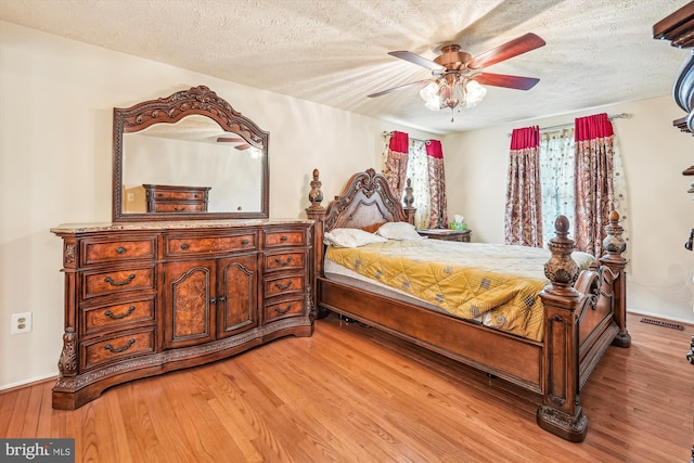 14616 Orangewood St, Silver Spring, MD 20905 - bedroom featuring light wood-type flooring, a textured ceiling, and a ceiling fan