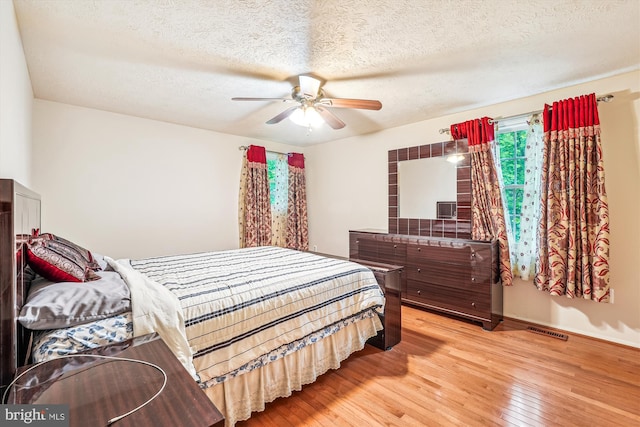 14616 Orangewood St, Silver Spring, MD 20905 - bedroom featuring light wood finished floors, a textured ceiling, and ceiling fan