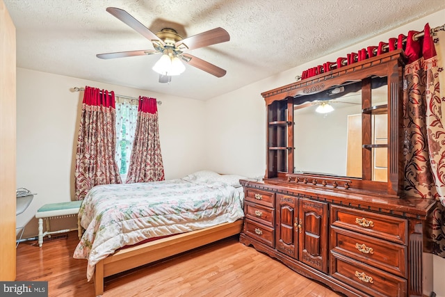 14616 Orangewood St, Silver Spring, MD 20905 - bedroom with light wood-style floors, a textured ceiling, and ceiling fan