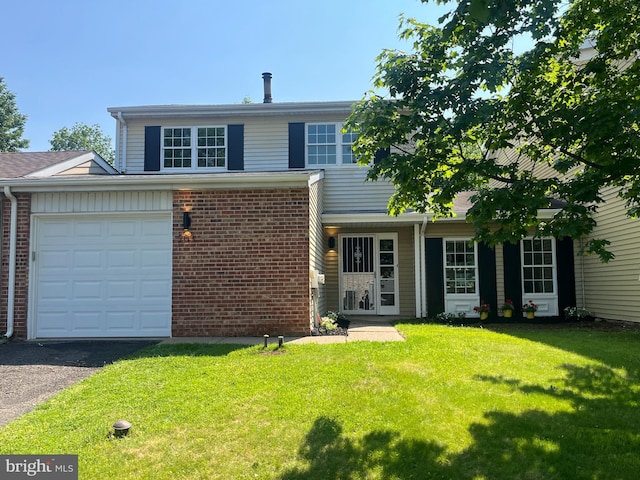 203 Commonwealth Dr, Newtown, PA 18940 - traditional home with a front lawn, brick siding, a garage, and asphalt driveway