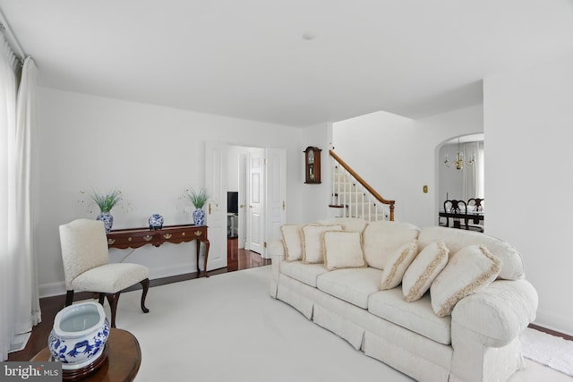 1022 S Beechfield Ave, Baltimore, MD 21229 - living room featuring stairway, arched walkways, baseboards, and wood finished floors