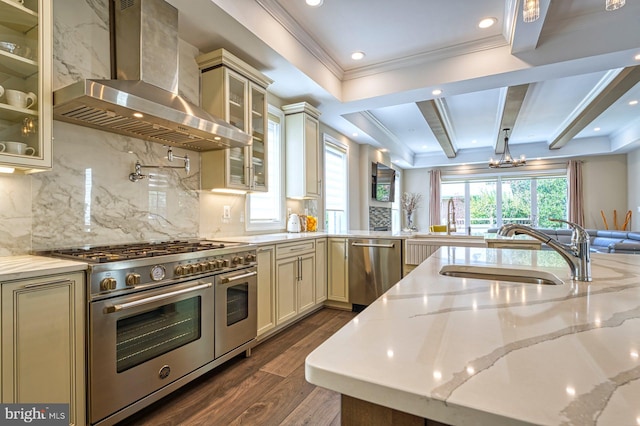1600 Great Falls St, Mclean, VA 22101 - kitchen with wall chimney exhaust hood, stainless steel appliances, a sink, cream cabinetry, and dark wood-type flooring