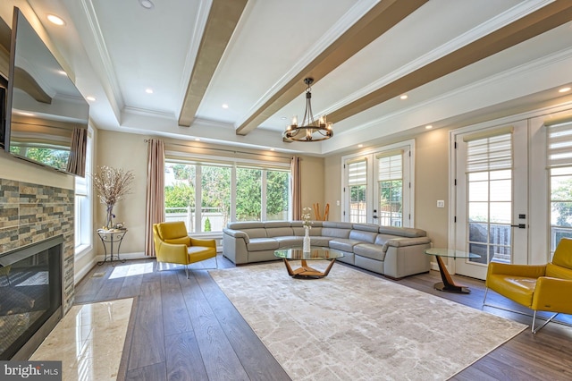 1600 Great Falls St, Mclean, VA 22101 - living room with a chandelier, hardwood / wood-style flooring, a stone fireplace, baseboards, and crown molding