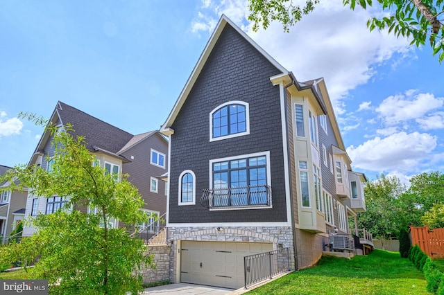 1600 Great Falls St, Mclean, VA 22101 - view of front facade with an attached garage, a front yard, driveway, and central AC