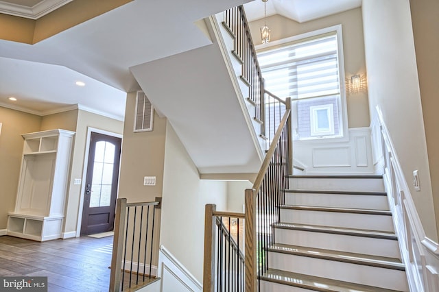 1600 Great Falls St, Mclean, VA 22101 - staircase with wood-type flooring, crown molding, recessed lighting, a chandelier, and a decorative wall