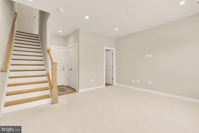2521 River Terrace Rd, Hyattsville, MD 20782 - unfurnished living room with carpet flooring, recessed lighting, stairs, and baseboards