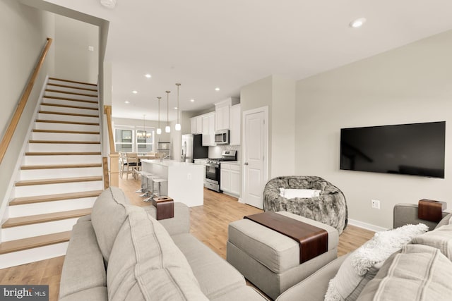 2521 River Terrace Rd, Hyattsville, MD 20782 - living area featuring stairs, light wood-style floors, recessed lighting, and baseboards
