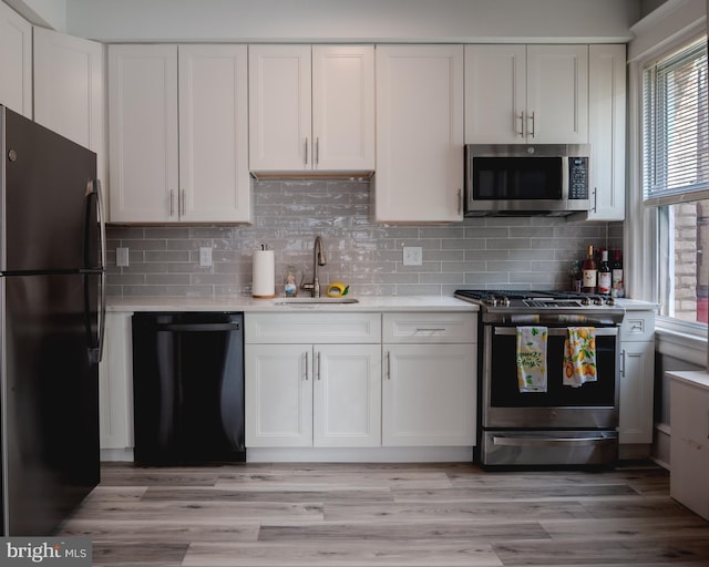 4805 Ventnor Ave Unit 4, Ventnor City, NJ 08406 - kitchen with black appliances, a sink, light countertops, and healthy amount of natural light