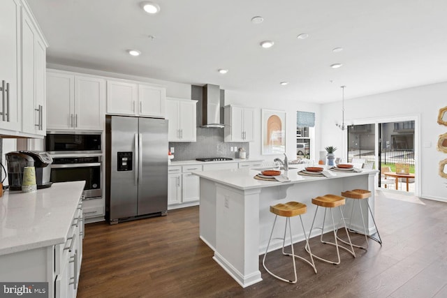 453 Ensemble Way, Frederick, MD 21701 - kitchen featuring stainless steel appliances, wall chimney range hood, dark wood-type flooring, white cabinetry, and recessed lighting