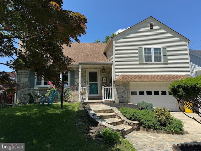 129 Redwood Ave, Trenton, NJ 08619 - split level home featuring stone siding, a shingled roof, an attached garage, a front yard, and driveway