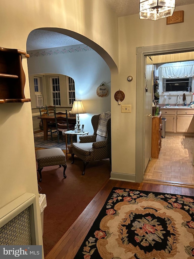 129 Redwood Ave, Trenton, NJ 08619 - entryway featuring arched walkways, light wood-style floors, and a textured ceiling