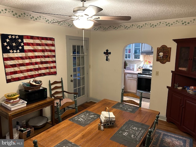 129 Redwood Ave, Trenton, NJ 08619 - dining area with ceiling fan, a textured ceiling, arched walkways, and wood finished floors
