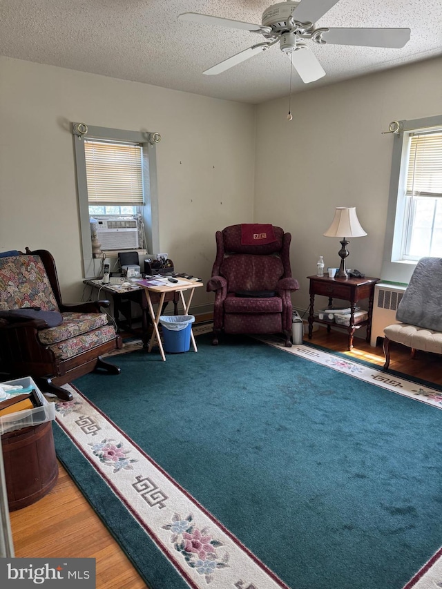 129 Redwood Ave, Trenton, NJ 08619 - living room featuring radiator, ceiling fan, wood finished floors, a textured ceiling, and cooling unit