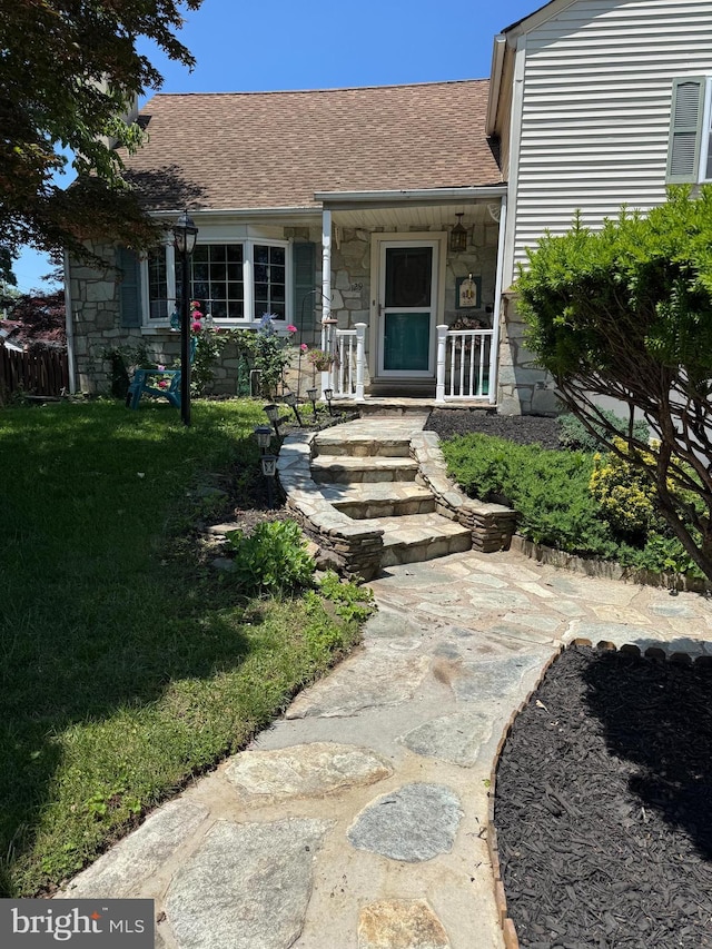 129 Redwood Ave, Trenton, NJ 08619 - view of front of home with stone siding, a front lawn, a porch, and a shingled roof