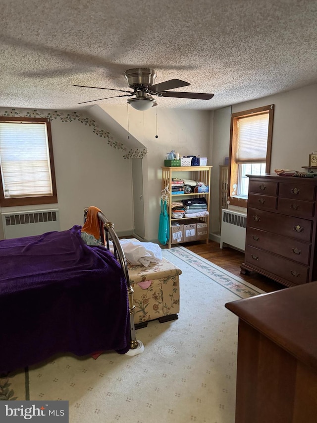 129 Redwood Ave, Trenton, NJ 08619 - bedroom featuring radiator heating unit, a textured ceiling, a ceiling fan, and wood finished floors