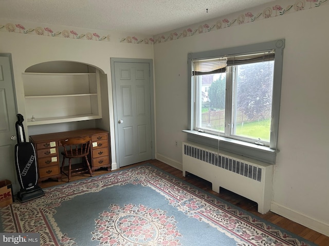 129 Redwood Ave, Trenton, NJ 08619 - unfurnished office featuring radiator heating unit, wood finished floors, a textured ceiling, and baseboards