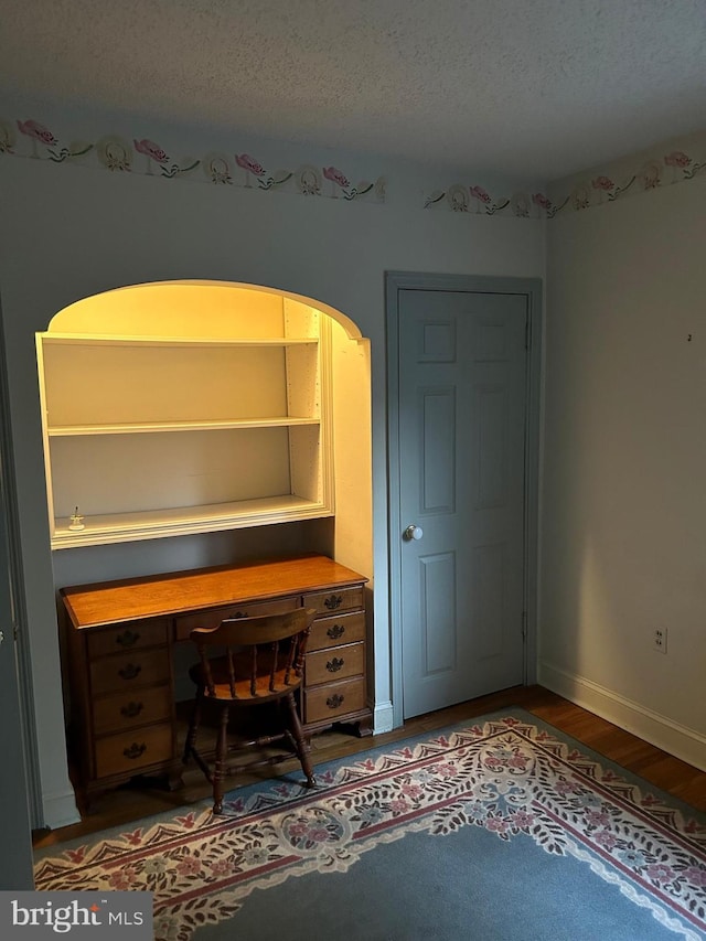 129 Redwood Ave, Trenton, NJ 08619 - office space featuring wood finished floors, a textured ceiling, baseboards, and arched walkways