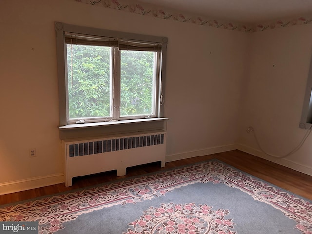 129 Redwood Ave, Trenton, NJ 08619 - empty room featuring radiator heating unit, wood finished floors, and baseboards