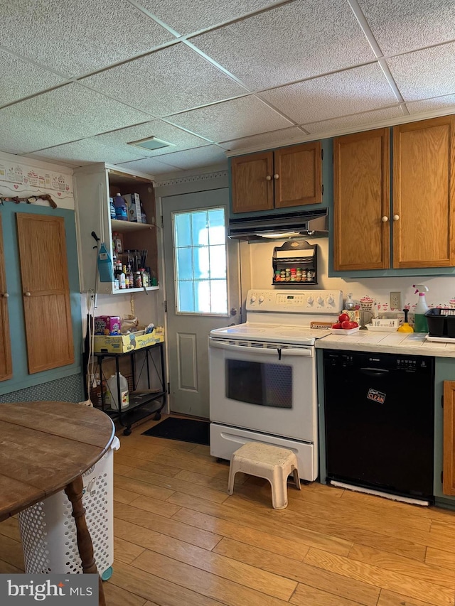 129 Redwood Ave, Trenton, NJ 08619 - kitchen with black dishwasher, electric range, under cabinet range hood, a drop ceiling, and light wood-style floors