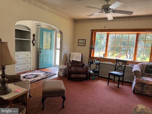 129 Redwood Ave, Trenton, NJ 08619 - living room featuring arched walkways, ceiling fan, a textured ceiling, and carpet