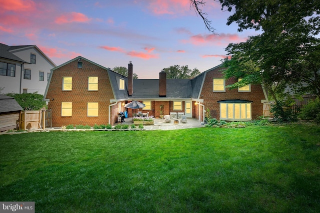 1440 Highwood Dr, Mclean, VA 22101 - rear view of house featuring a gambrel roof, brick siding, a chimney, and a patio