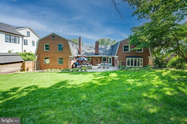 1440 Highwood Dr, Mclean, VA 22101 - back of property with a gambrel roof, a chimney, a patio area, and brick siding