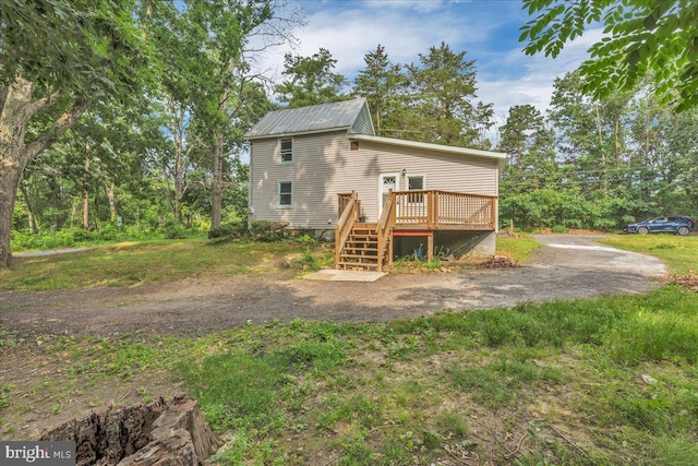 70 Steinfeld Ave, Pittsgrove, NJ 08318 - back of property with a wooden deck, stairs, and a metal roof