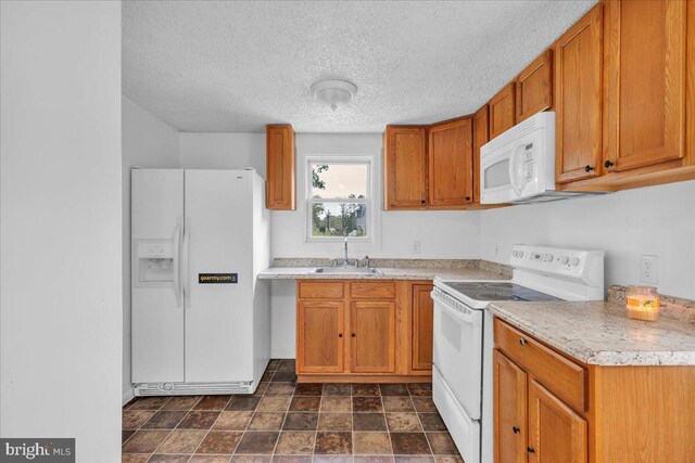70 Steinfeld Ave, Pittsgrove, NJ 08318 - kitchen featuring white appliances, brown cabinetry, light countertops, a textured ceiling, and dark stone finish flooring