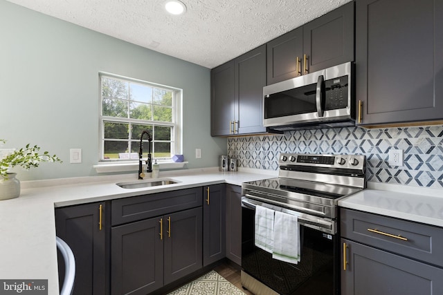1207 Blithe Ct, Upper Marlboro, MD 20774 - kitchen with stainless steel appliances, a sink, light countertops, a textured ceiling, and tasteful backsplash