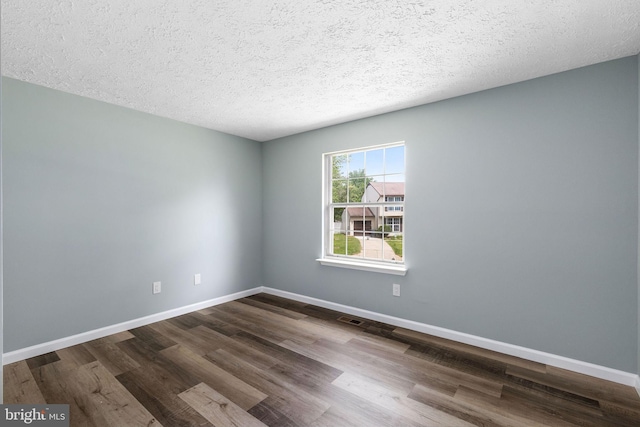 1207 Blithe Ct, Upper Marlboro, MD 20774 - empty room featuring dark wood-style floors, a textured ceiling, and baseboards