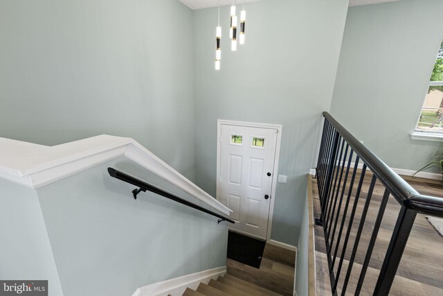 1207 Blithe Ct, Upper Marlboro, MD 20774 - staircase featuring wood finished floors, baseboards, and a chandelier