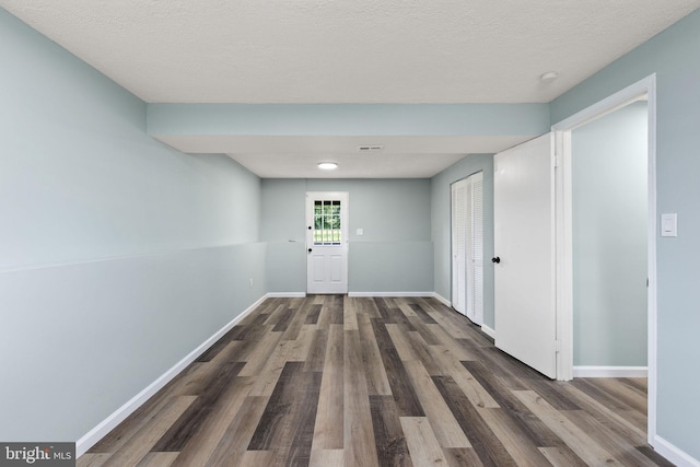 1207 Blithe Ct, Upper Marlboro, MD 20774 - hall featuring wood finished floors, baseboards, and a textured ceiling